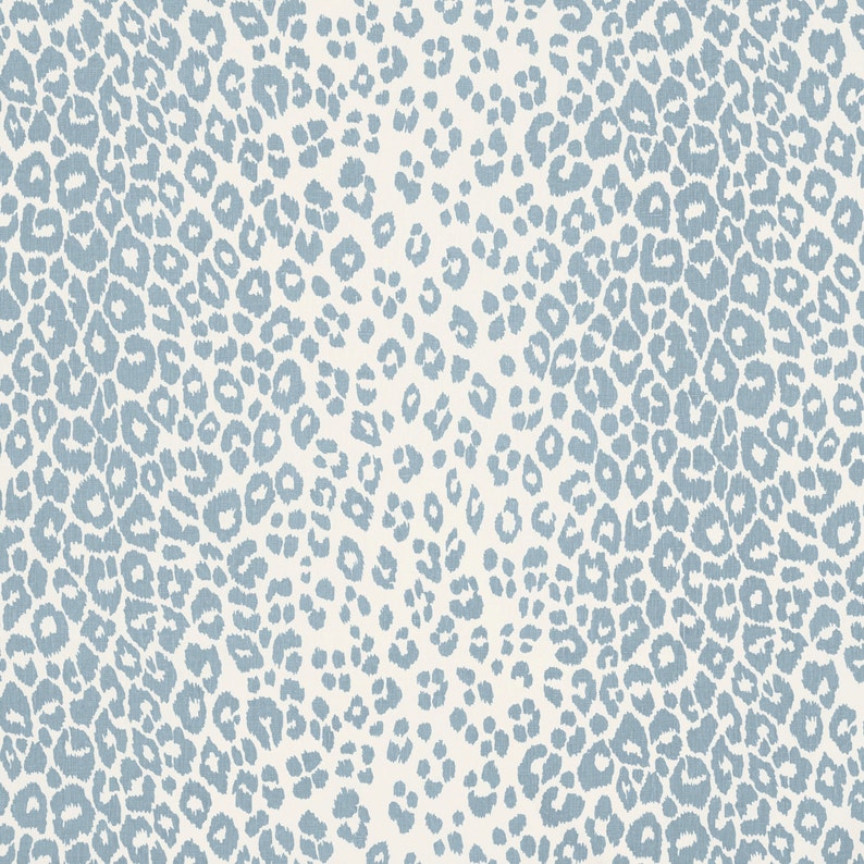 May include: A seamless pattern of blue leopard spots on a white background.