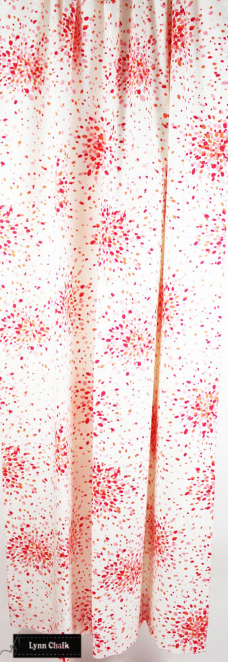 May include: White fabric with a red, pink and orange confetti pattern. The fabric is folded in half and the bottom edge is visible. The text "Lynn Chalk" is visible at the bottom of the image.