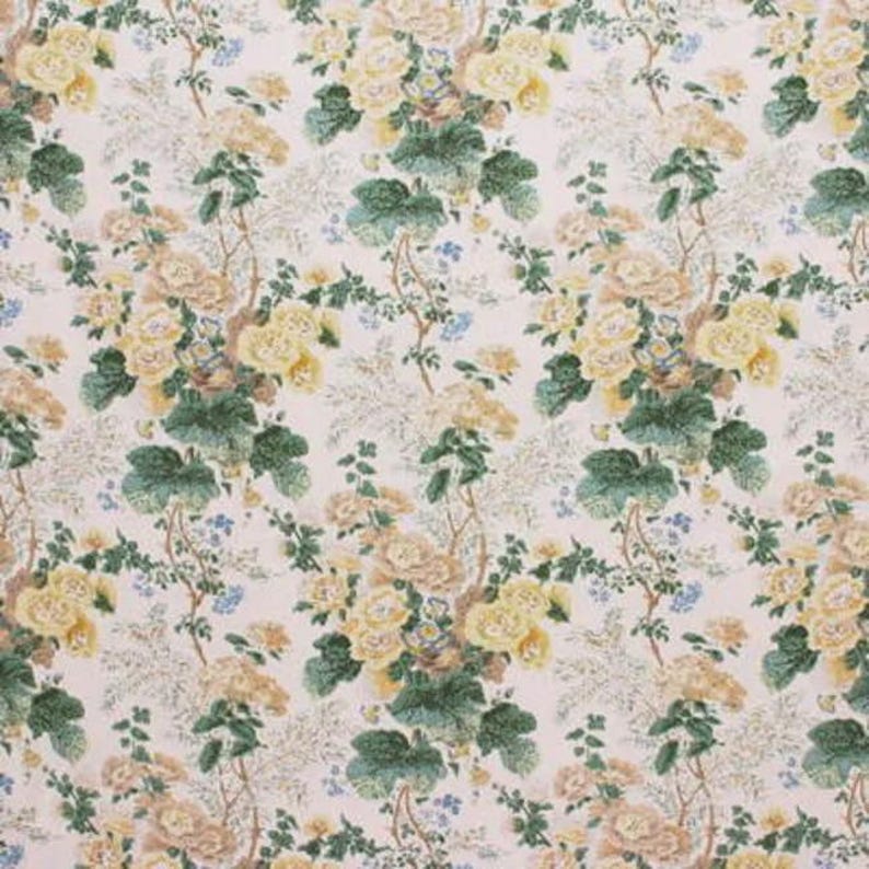May include: Floral fabric with a repeating pattern of yellow and tan roses, green leaves, and small blue flowers on a cream background. The design has a vintage, botanical aesthetic, suitable for upholstery or crafting.