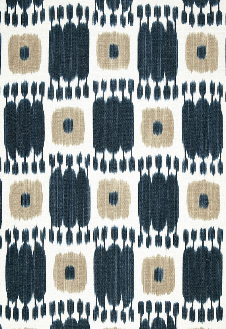 May include: A white fabric with a repeating pattern of blue and tan geometric shapes. The pattern is a stylized ikat design.