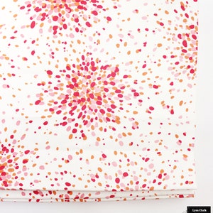 May include: White fabric with a repeating pattern of pink, orange, and red dots arranged in a burst pattern.