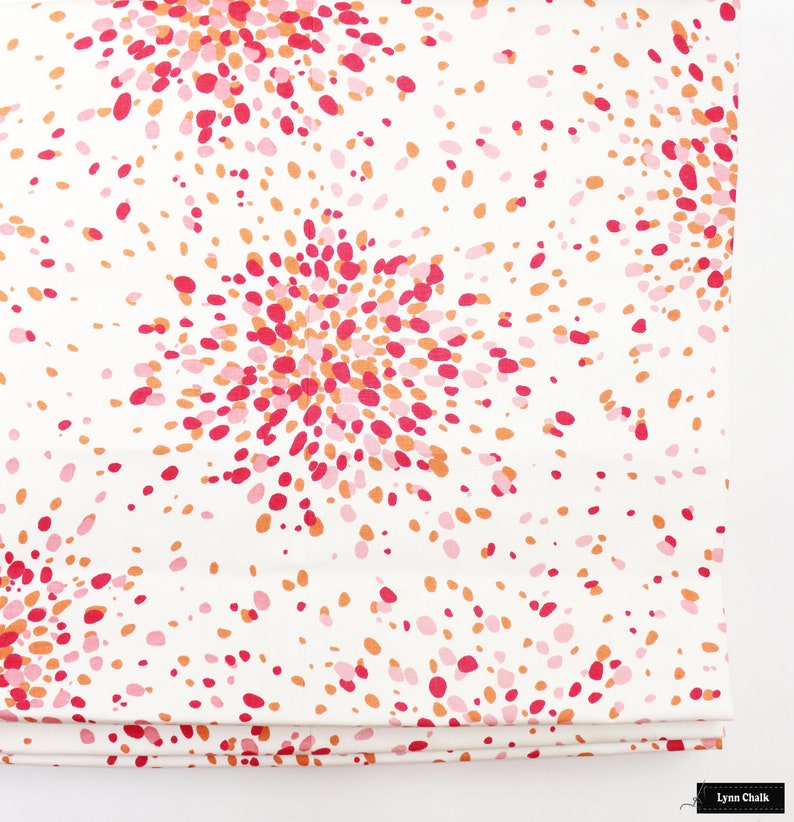 May include: White fabric with a repeating pattern of pink, orange, and red dots arranged in a burst pattern.