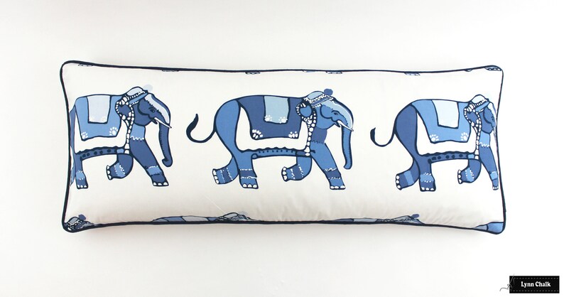 Puede incluir: Una almohada rectangular larga con fondo blanco y un patr&oacute;n repetido de elefantes azules. Los elefantes est&aacute;n decorados con detalles azules y blancos y caminan en l&iacute;nea.