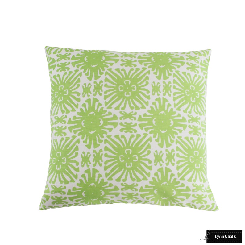 May include: Green and white throw pillow with a geometric pattern of stylized flowers. The pillow is made of a soft, textured fabric.