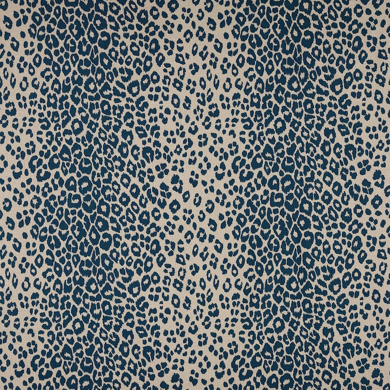 May include: A fabric with a blue and beige leopard print pattern.