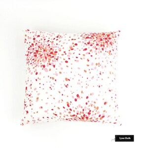 May include: White pillow cover with a pink, red and orange confetti pattern. The pattern is a burst of colour on a white background.