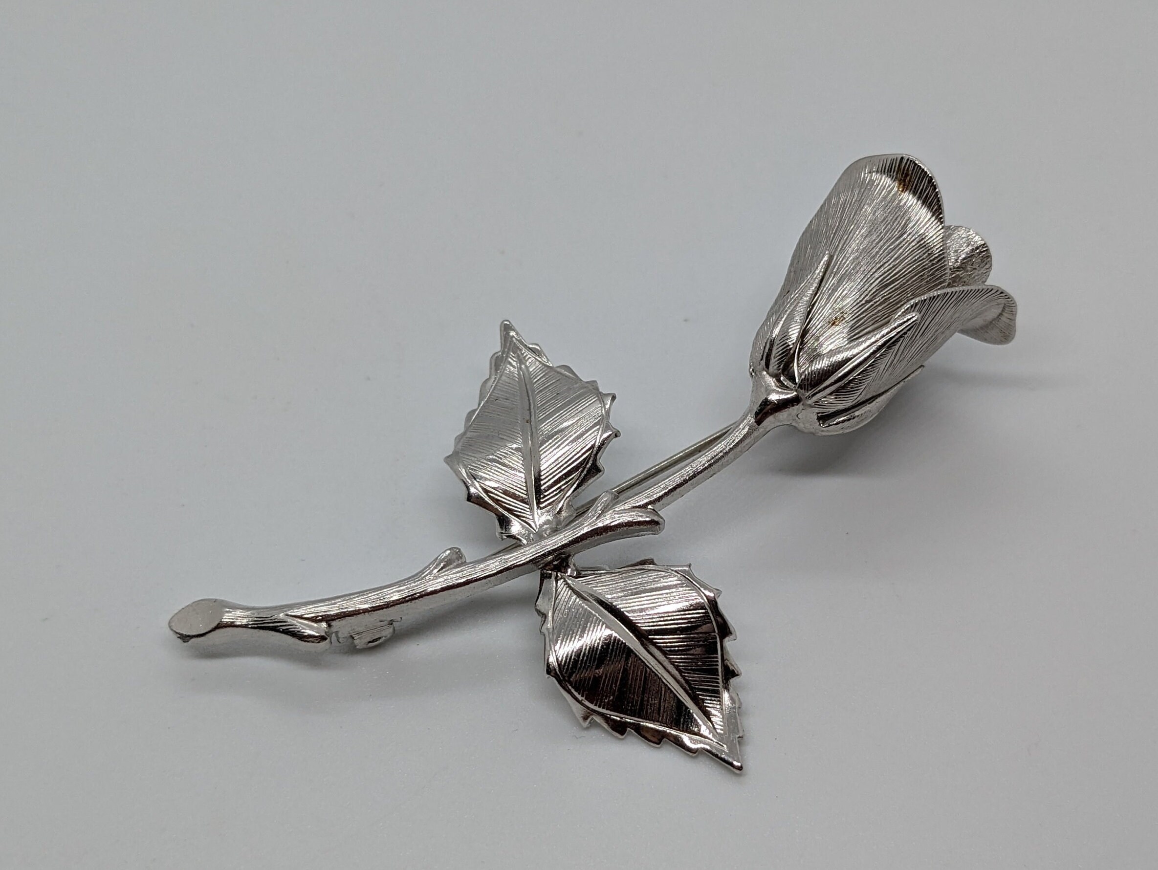 Silver rose brooch deals