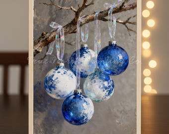 May include: A framed painting of five blue and white Christmas ornaments hanging from a tree branch. The ornaments have a speckled design and are suspended by sheer ribbons. The background is a muted gray with the text "True North Painting Co."