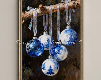 May include: A framed painting of Christmas ornaments. Five blue and white ornaments with tree designs hang from a tree branch. The ornaments are suspended by iridescent ribbons. The text "True North Printing Co." is visible.