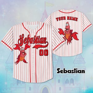 May include: White baseball jersey with red pinstripes, displaying the name "Sebastian" in red script and the number "00". The jersey features a cartoon image of a red crab. The back of the jersey says "YOUR NAME".