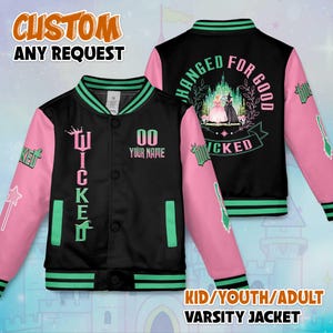 May include: Black varsity jacket with pink sleeves and green trim. The front has the word "Wicked" in green, a crown, and space for a name and number. The back shows a "Wicked" design with the text "Changed for Good".