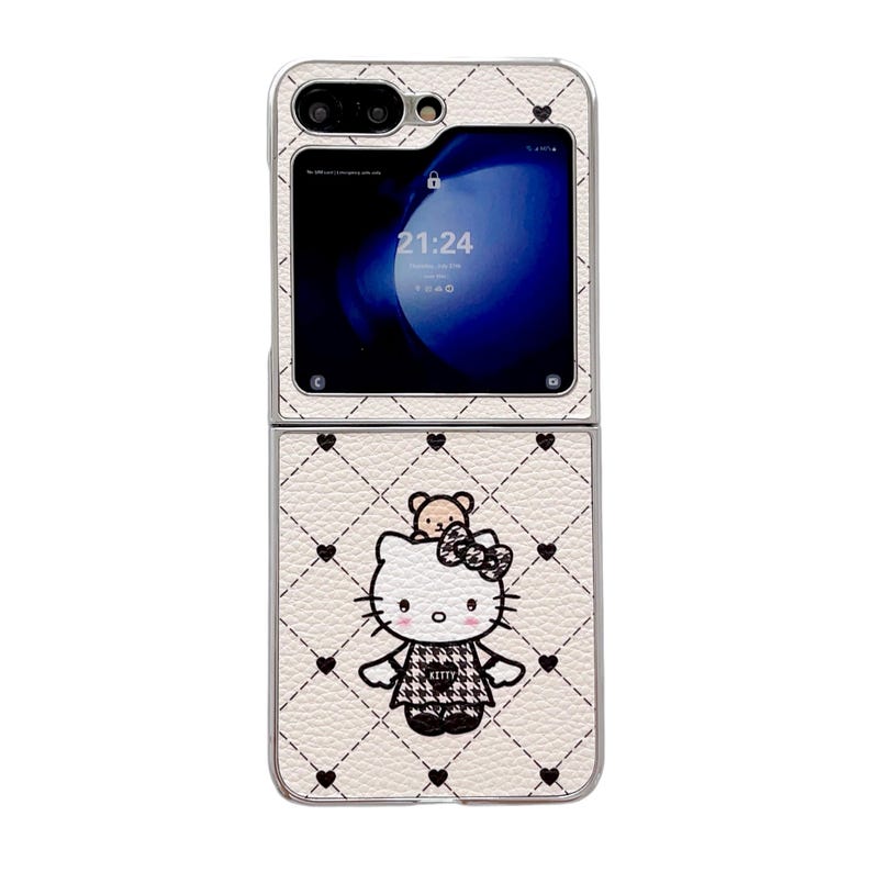 May include: A white, foldable phone case with a quilted pattern and black heart accents. The case features a Hello Kitty graphic with a bear and bow. The phone screen displays the time 21:24.