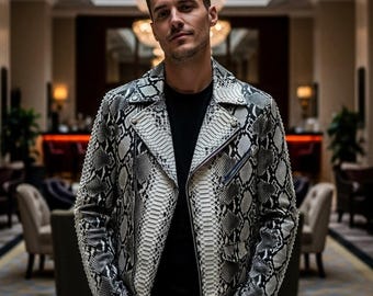 May include: A black and white snakeskin-patterned leather jacket with a zipper closure. The jacket has a classic biker style with a notched collar and multiple pockets. The jacket is worn over a black shirt.