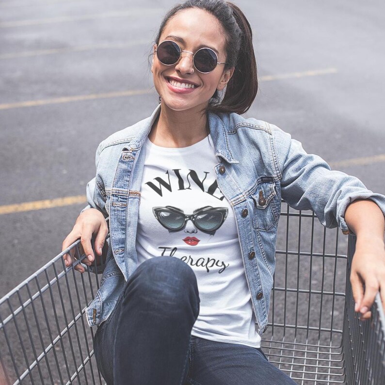 retro wine therapy tshirt with large cat eye sunglasses Wine Therapy Bella TShirt Retro Cat Eye Sunglasses Funny Wine Lover Tee Wine Mom Shirt Wine Gift for Her Vintage Wine Glamour Sunglasses Tee woman sitting in shopping cart wearing dark sunglasses