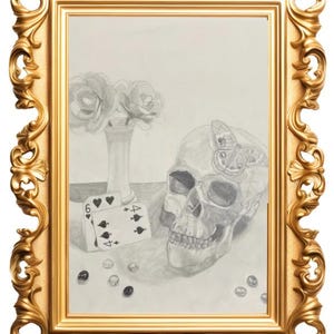 May include: A pencil drawing of a skull with butterfly designs, playing cards, and a vase of flowers, framed in a gold ornate frame. The playing cards show a six of hearts and a four of spades. The frame is gold.