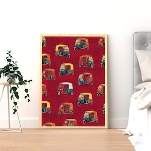 May include: A framed print featuring a repeating pattern of colorful auto rickshaws on a deep red background. The rickshaws are in various colors, including yellow, blue, red, and white, creating a vibrant and eye-catching design.