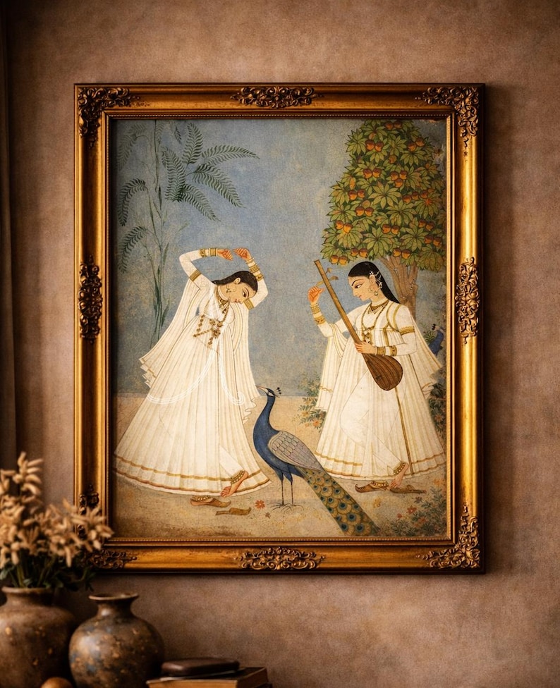 May include: A framed painting with a gold ornate frame shows two figures in white robes, one playing a stringed instrument, the other with arms raised. A peacock stands between them. The artwork is set against a backdrop of a tree and a blue sky.