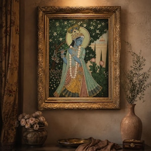May include: A framed painting depicting a blue-skinned figure playing a flute, adorned with a peacock feather crown and layered necklaces. The figure wears a light green and yellow garment, set against a backdrop of dark green foliage and white flowers.