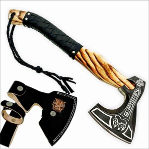 May include: A handcrafted axe with a wooden handle and a black leather-wrapped grip. The axe head is black with silver decorative patterns and a bear claw design. Includes a black leather sheath with a belt loop and the text "SHINY CRAFTS".