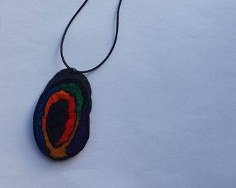 Handfelted merino wool oval rainbow spiral pendant on a black satin cord necklace with silver colour lobster clasp
