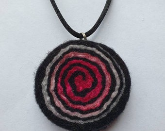 Handfelted graduating silver, white, light & dark pink mulberry silk and wool spiral pendant on a black satin cord necklace