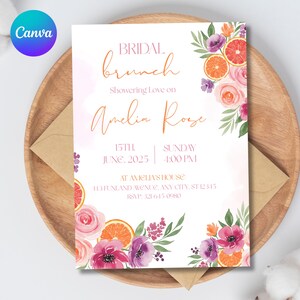 May include: A bridal brunch invitation with watercolor floral and citrus accents. The invitation features the text "BRIDAL brunch" and "Amelia Rose" in elegant script. The date and time are also included, along with RSVP information.