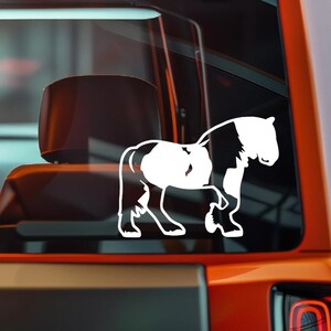 May include: A white vinyl decal of a horse in a side profile, with black markings. The horse is depicted with its legs in a walking position. The decal is applied to a vehicle window.