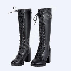 May include: A pair of black knee-high boots with a lace-up design and block heels. The boots feature silver eyelets and a small decorative emblem on the side. The soles have a subtle tread, and the heels measure approximately 3 inches.