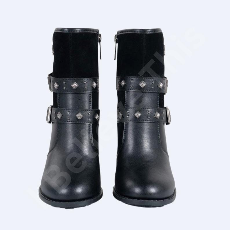 May include: Black leather ankle boots with a suede upper and studded straps. The boots have a side zip and buckle fastenings. The design features silver metal accents and a rounded toe.