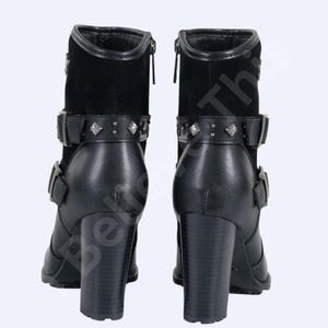 May include: Pair of black leather ankle boots with a block heel. The boots feature a suede upper, silver-tone studded strap, and buckle closures. The heels are approximately 7.6 cm high.