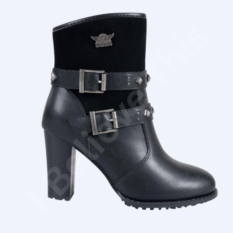 May include: Black leather ankle boot with a block heel. The boot features two buckled straps with silver-tone studs and a black suede upper. A silver-tone emblem is on the upper shaft. The boot has a rounded toe and a sturdy heel.