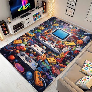 May include: A colorful area rug featuring a vibrant collage of retro video game controllers, consoles, and accessories. The rug's design includes a large screen, game cartridges, and various buttons, creating a playful and nostalgic theme.
