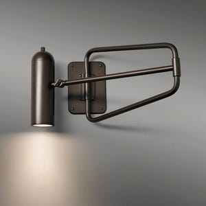 May include: A bronze-colored wall-mounted lamp with a cylindrical light fixture and an adjustable arm. The lamp is mounted on a rectangular backplate. The light shines downward, illuminating the area below.