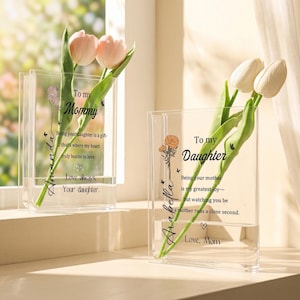 May include: Two clear acrylic vases with floral arrangements. One vase has pink tulips and the text "To my Mommy" and "Amanda". The other vase has white tulips and the text "To my Daughter" and "Arabella". Both vases have additional text.