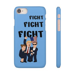 May include: A light blue phone case with the word "FIGHT" repeated three times in black. The case features a cartoon illustration of three people, one holding an American flag. The side of the case is light blue with pink buttons.