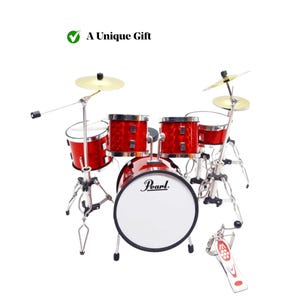 May include: A miniature red drum kit with silver stands and cymbals. The bass drum has the "Pearl" logo. The image includes the text "A Unique Gift".