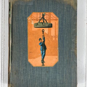 May include: A vintage blue book with a worn cover. The front cover features a colorful illustration of a man climbing a chain attached to a large metal disc.
