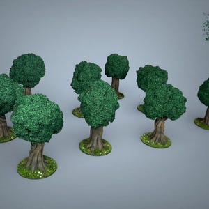 May include: A set of miniature forest trees with textured green foliage and brown trunks. The trees are set on small, round bases with green grass and tiny white flowers. The trees are designed for tabletop gaming or model scenery.