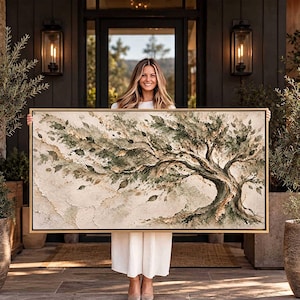 May include: A rectangular landscape painting in a thin gold frame featuring a stylized tree with textured, sweeping branches and leaves in shades of sage green, olive, and cream. The artwork displays a layered, impasto-style application of paint.