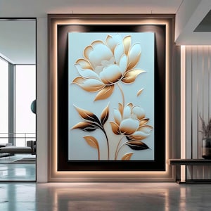 Puede incluir: Una obra de arte floral enmarcada. La obra presenta dos flores estilizadas blancas y doradas con pétalos y hojas detallados sobre un fondo azul claro. El marco es marrón oscuro con un borde claro. Para decoración de pared.