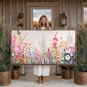 May include: A rectangular canvas painting featuring a vibrant meadow of wildflowers in shades of pink, white, and yellow against a soft neutral background. A single monarch butterfly is depicted on the left side of the floral arrangement.