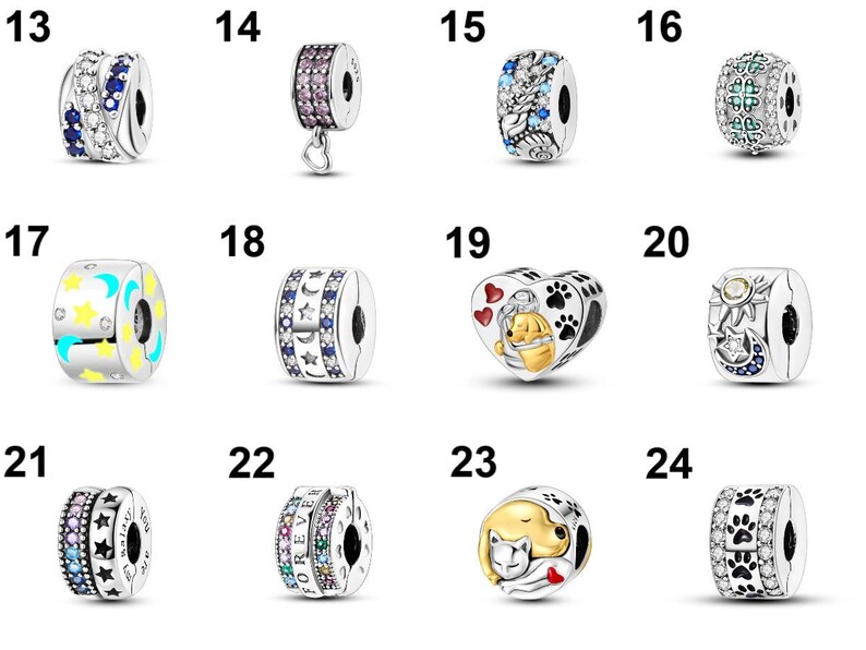 May include: A collection of silver charm beads with various designs. Some beads feature colorful gemstones, while others have celestial motifs like stars and moons. Several charms have heart, paw print, and Winnie the Pooh designs.