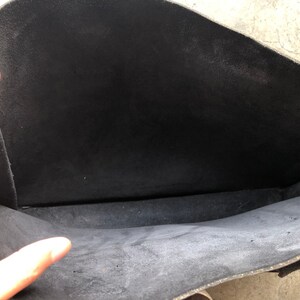 Puede incluir: El interior de una bolsa de cuero negra. La bolsa est&aacute; vac&iacute;a y el forro es de color gris oscuro.