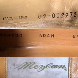 May include: Close-up of the interior of a brown leather shoe. The shoe is labeled "Havana" and "404M". The size is 8 1/2. The shoe is made in Spain and has a serial number 09-002972. The brand name "Meylan" is visible on a white label.