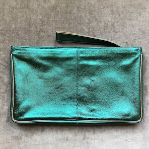 May include: A metallic green clutch purse with a gold trim and a short handle.