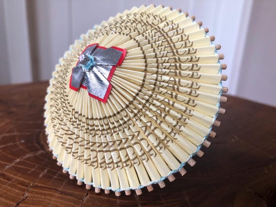 A tiny hand-folded origami parasol made from recycled paper in the Japanese wagasa tradition — a genuinely artisan miniature object with real craft heritage.