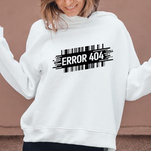 May include: White hoodie with the text "ERROR 404" in black, designed with a barcode-like graphic. The hoodie is a casual style, suitable for everyday wear.