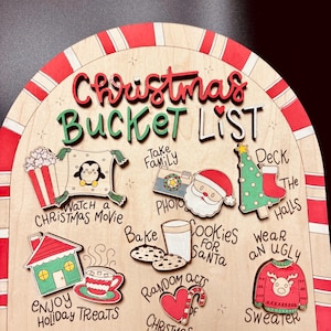 May include: Wooden Christmas Bucket List sign with red and green lettering and decorative icons. Includes phrases like "Watch a Christmas Movie," "Bake Cookies for Santa," and "Send a Letter."