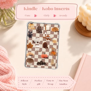 May include: A Kindle/Kobo insert with a checkered pattern and various miniature food and animal designs. The insert features a pancake, pinecone, toast, cinnamon roll, fox, coffee cup, maple leaf, pumpkin, bear, and other cute figures. The text reads "Kindle/Kobo Inserts."