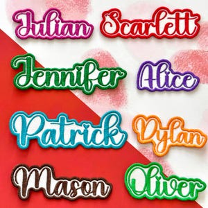 May include: Embroidered name patches in various colors, including pink, red, green, purple, blue, orange, and brown. Names include Julian, Scarlett, Jennifer, Alice, Patrick, Dylan, Mason, and Oliver. The patches have a white outline.